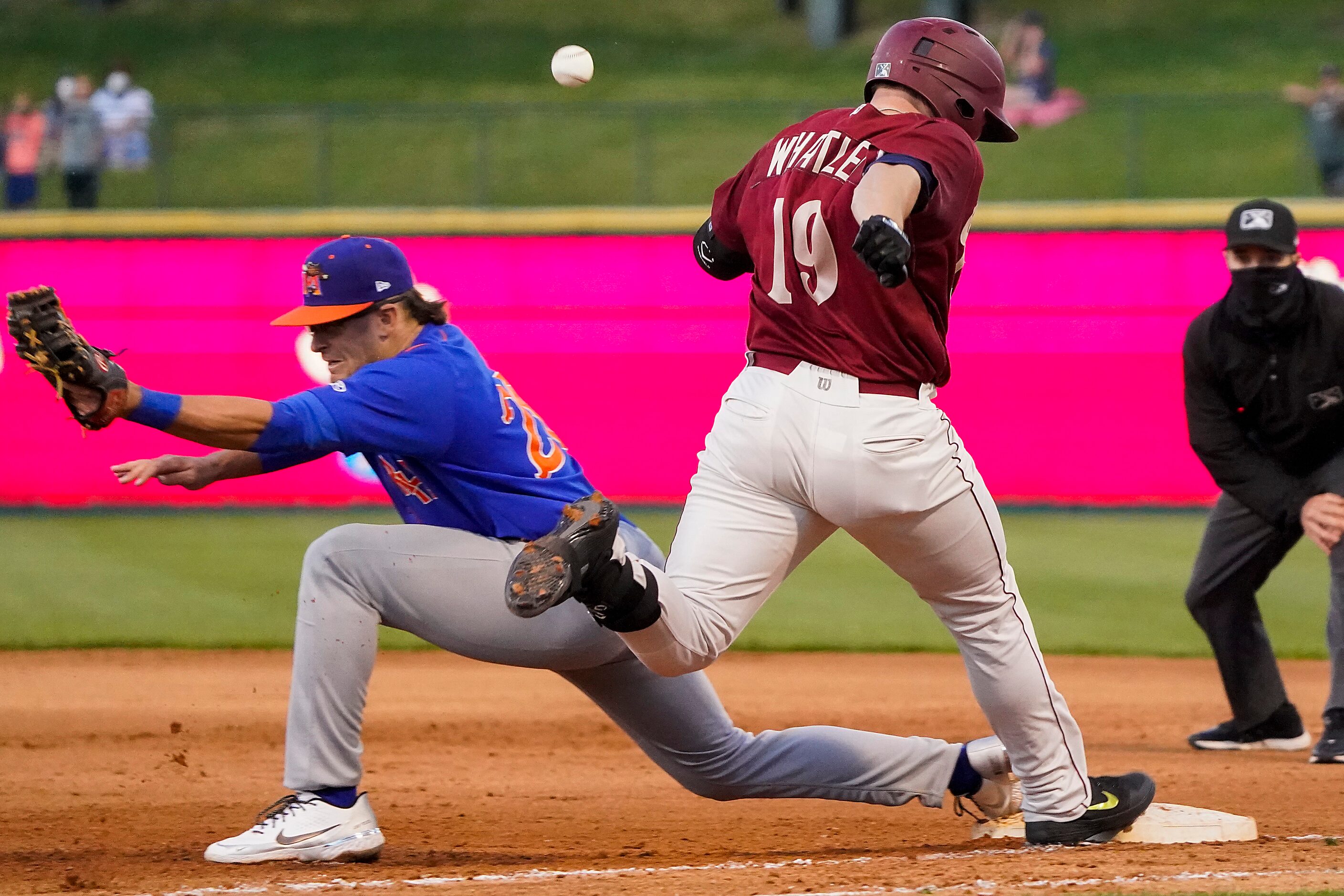 Frisco RoughRiders catcher Matt Whatley is save at first as the ball gets away from Midland...