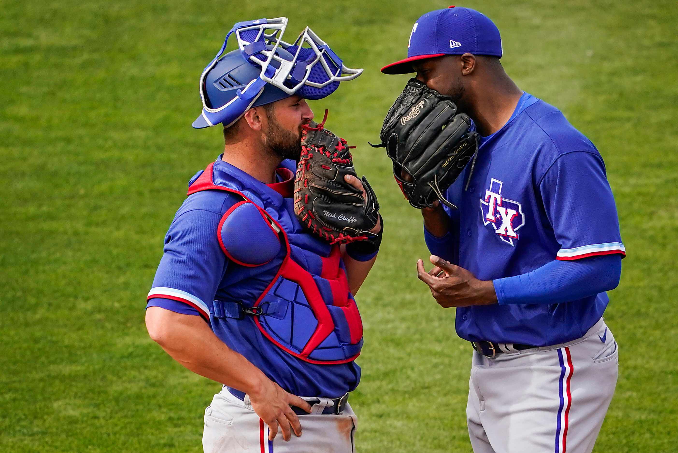 Texas Rangers pitcher James Jones confers with catcher Nick Ciuffo after coming into the...