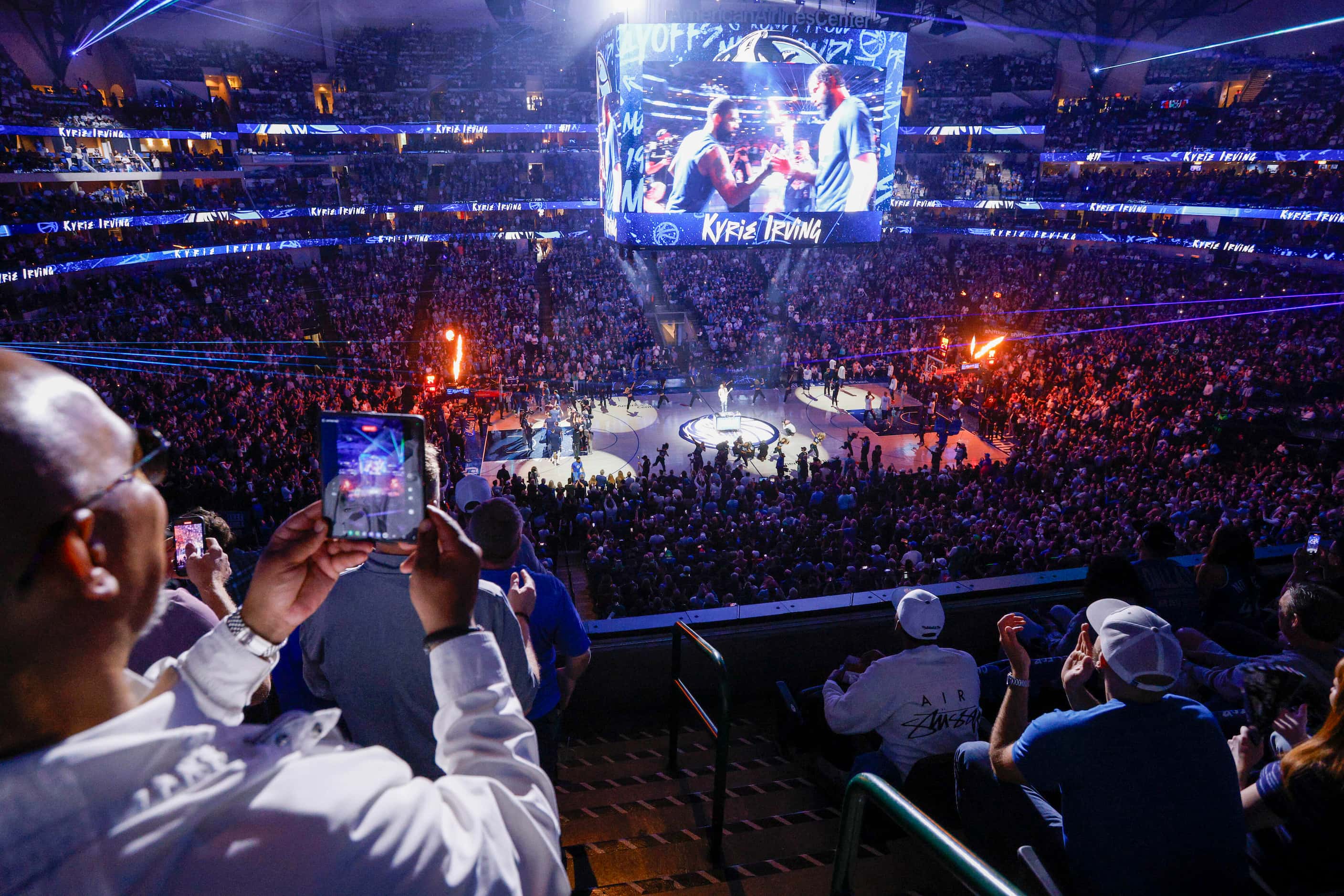 Fans stand and cheer as the Dallas Mavericks are introduced before an NBA basketball...