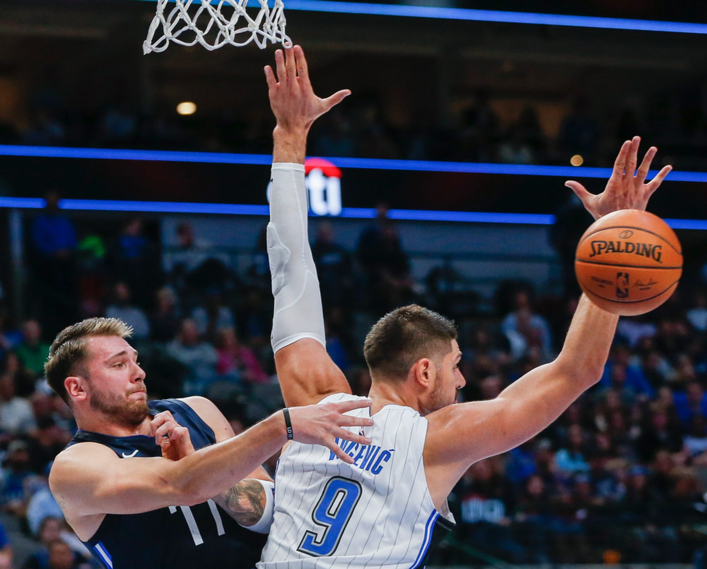 Dallas Mavericks guard Luka Doncic (77) fires off a pass behind the back of Orlando Magic...