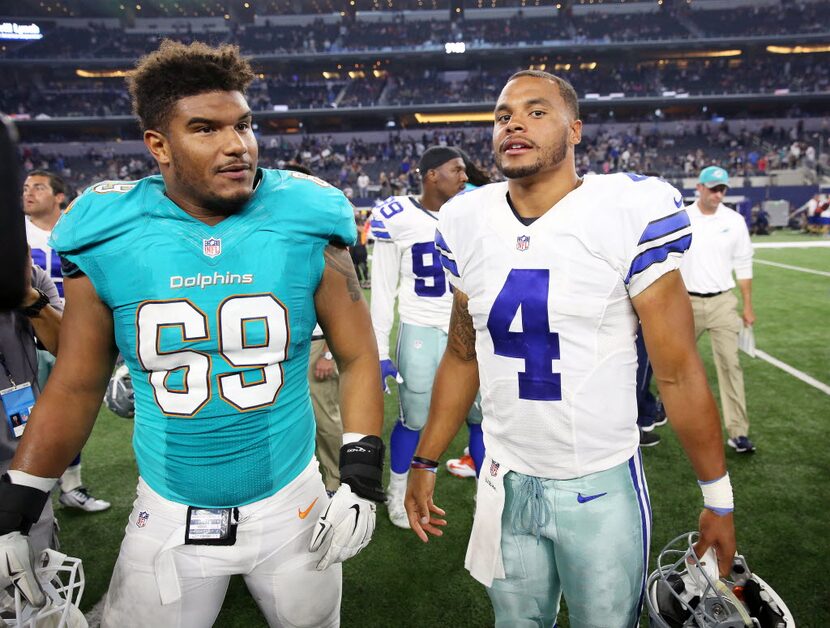 Dallas Cowboys quarterback Dak Prescott (4) speaks with Miami Dolphins defensive end Jordan...