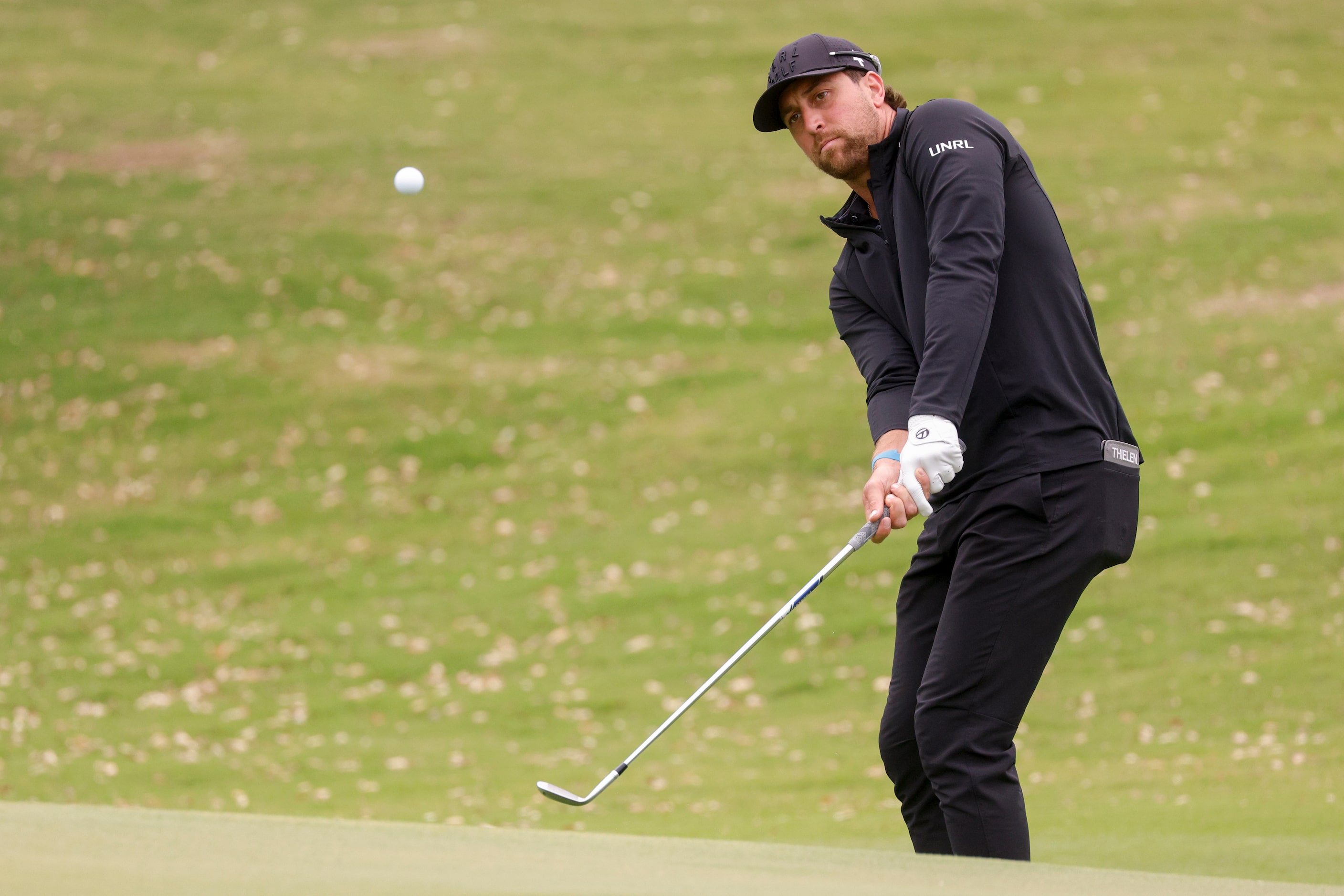 NFL wide receiver Adam Thielen chips onto the 9th green during the first round of the...