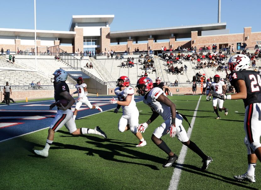 Coppell player 2, Brady McBride, runs in a touchdown during a Class 6A division I playoff...