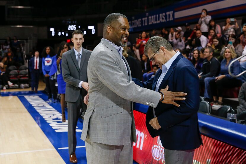 Southern Methodist Mustangs head coach Travis Mays, left, greets UConn Huskies head coach...