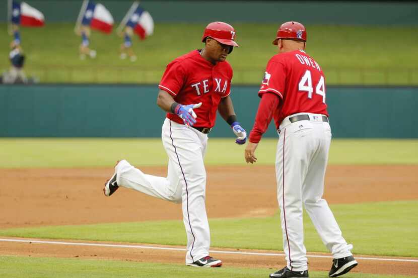 Texas Rangers' Adrian Beltre, left, is congratulated by interim third base coach Spike Owen...