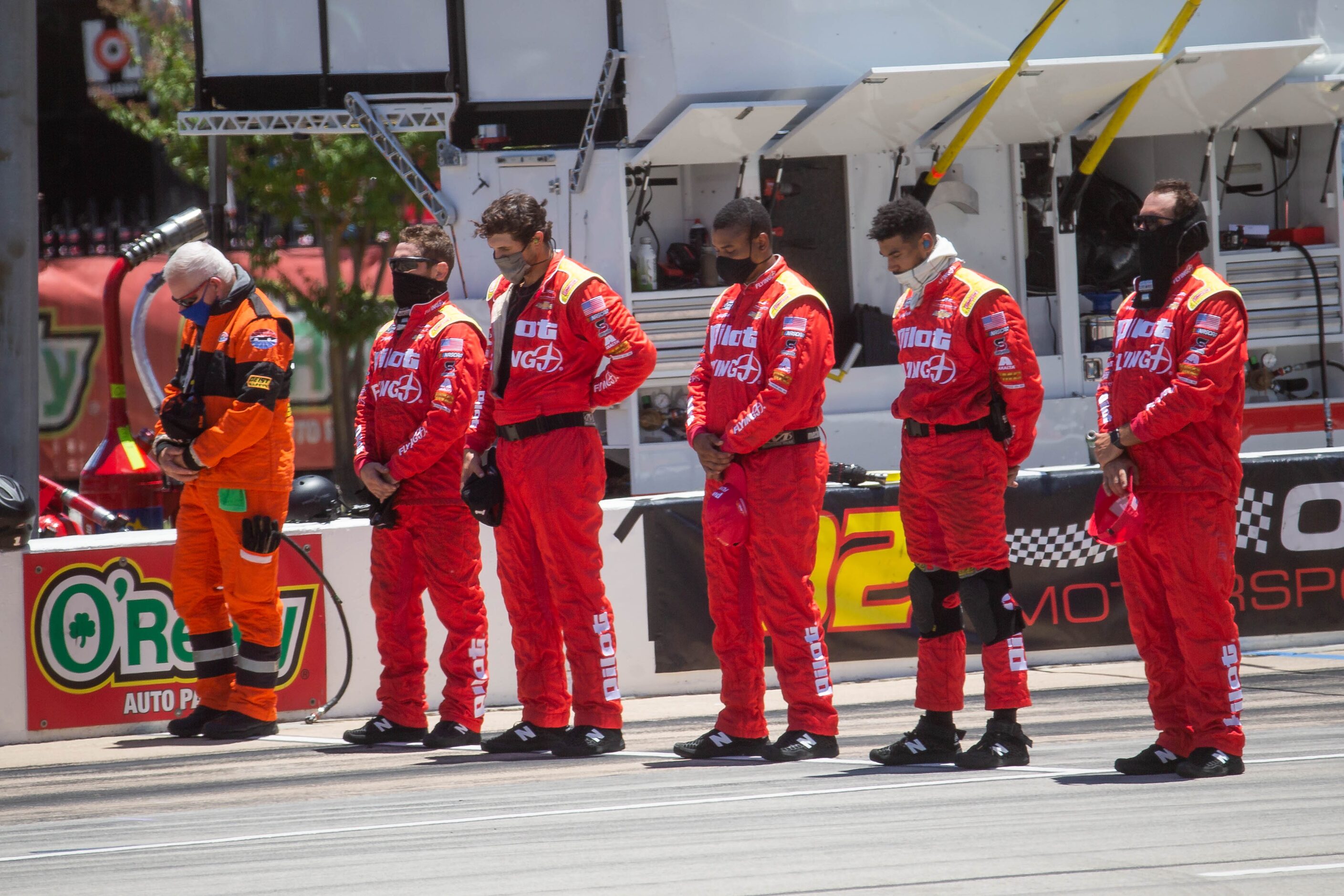 The Pilot Flying J crew bows their head during the pre-race invocation before the NASCAR...