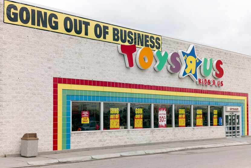 A "Going Out Of Business" sign hangs over the Toys R Us store logo in Omaha, Neb.