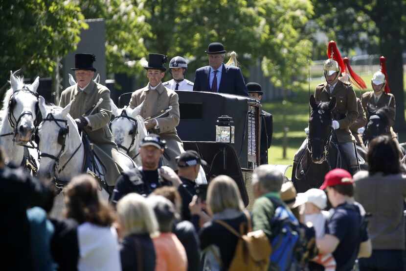The Crown Equerry Colonel Toby Brown (center), head of the Royal Mews sits atop the Ascot...