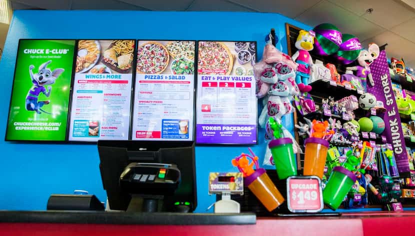 
A new digital menu board is displayed behind the counter at Chuck E Cheese on Wednesday,...