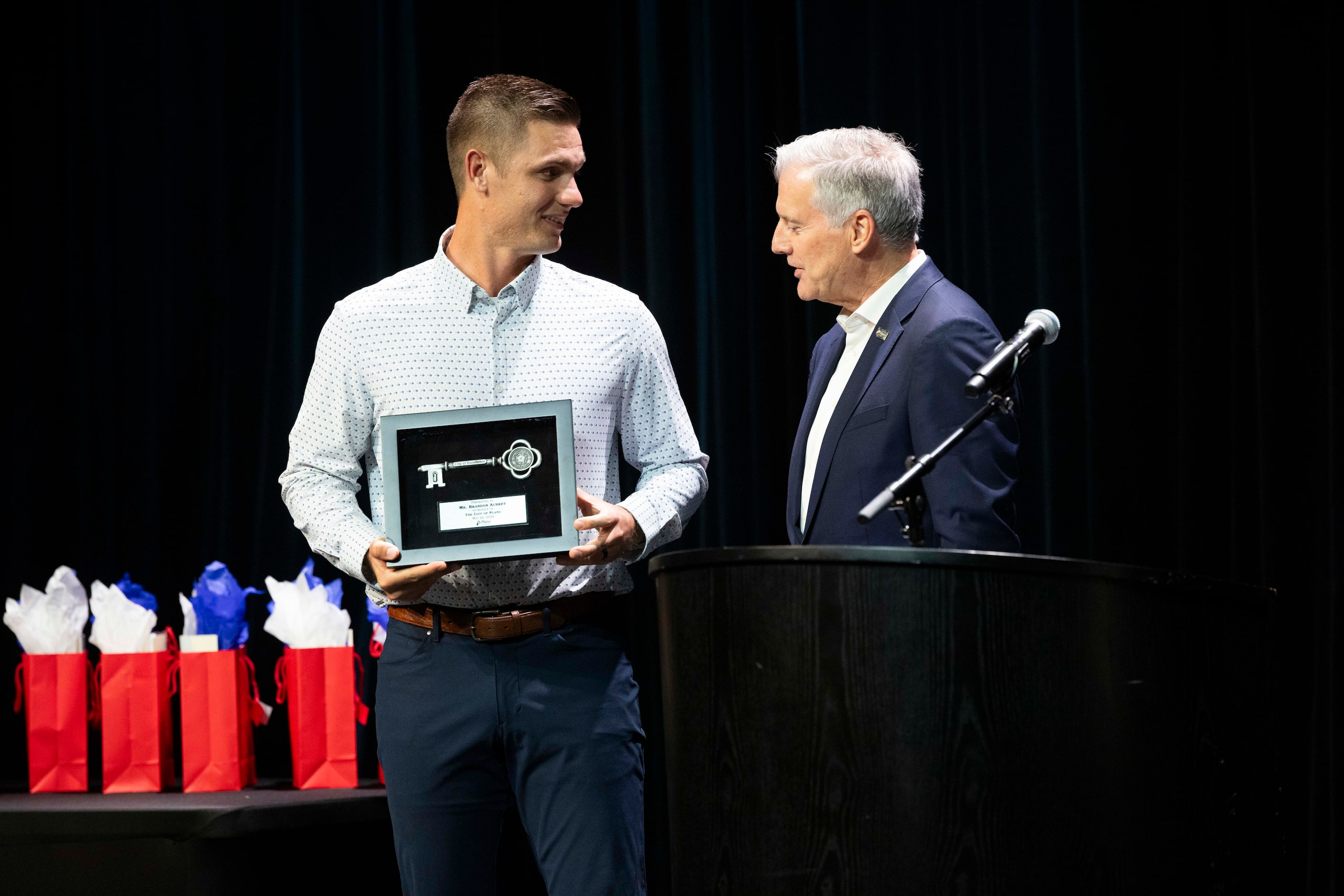 Plano native and Dallas Cowboys kicker Brandon Aubrey, left, is presented the key to the...