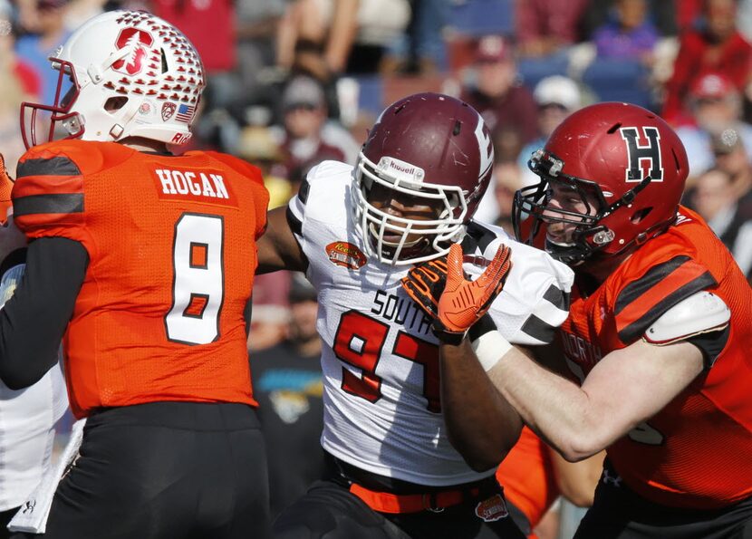 North squad offensive tackle Cole Toner of Harvard (79) fails at holding back South squad...