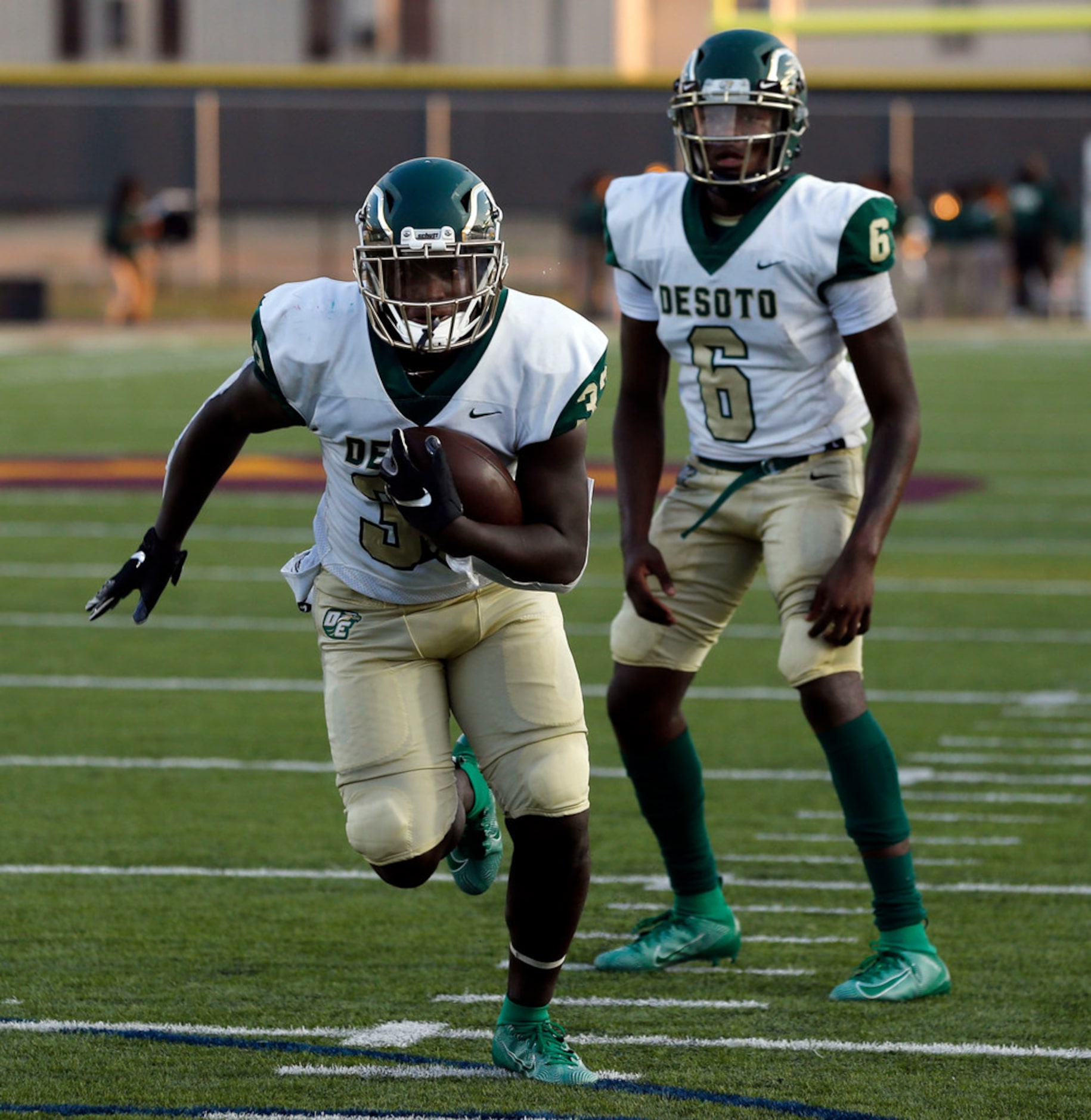 Desoto QB Samari Collier (6) watches RB Chris Henley (33) head to the end zone for a...