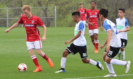 Berin Droemer holds off FC Dinastia defenders as FC Dallas U14s beat FC Dinastia 4-0 in the...