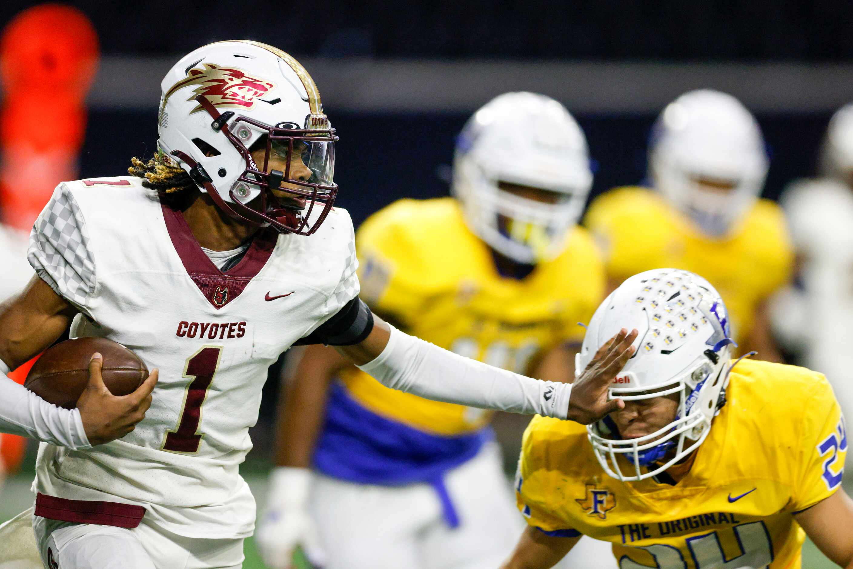 Frisco Heritage defensive back Kameron Franklin (1) stiff-arms Frisco defensive back Josh...