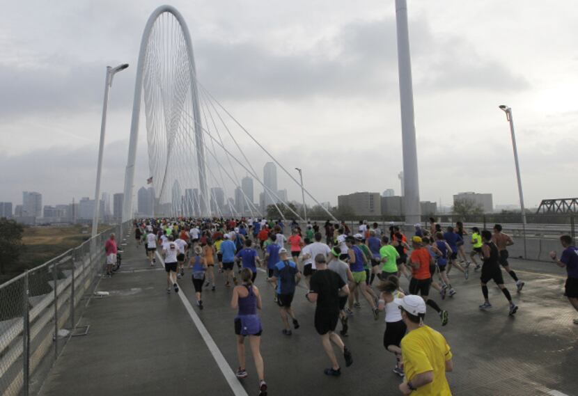 Runners head east across the Margaret Hunt Hill Bridge during the MetroPCS Dallas Marathon...