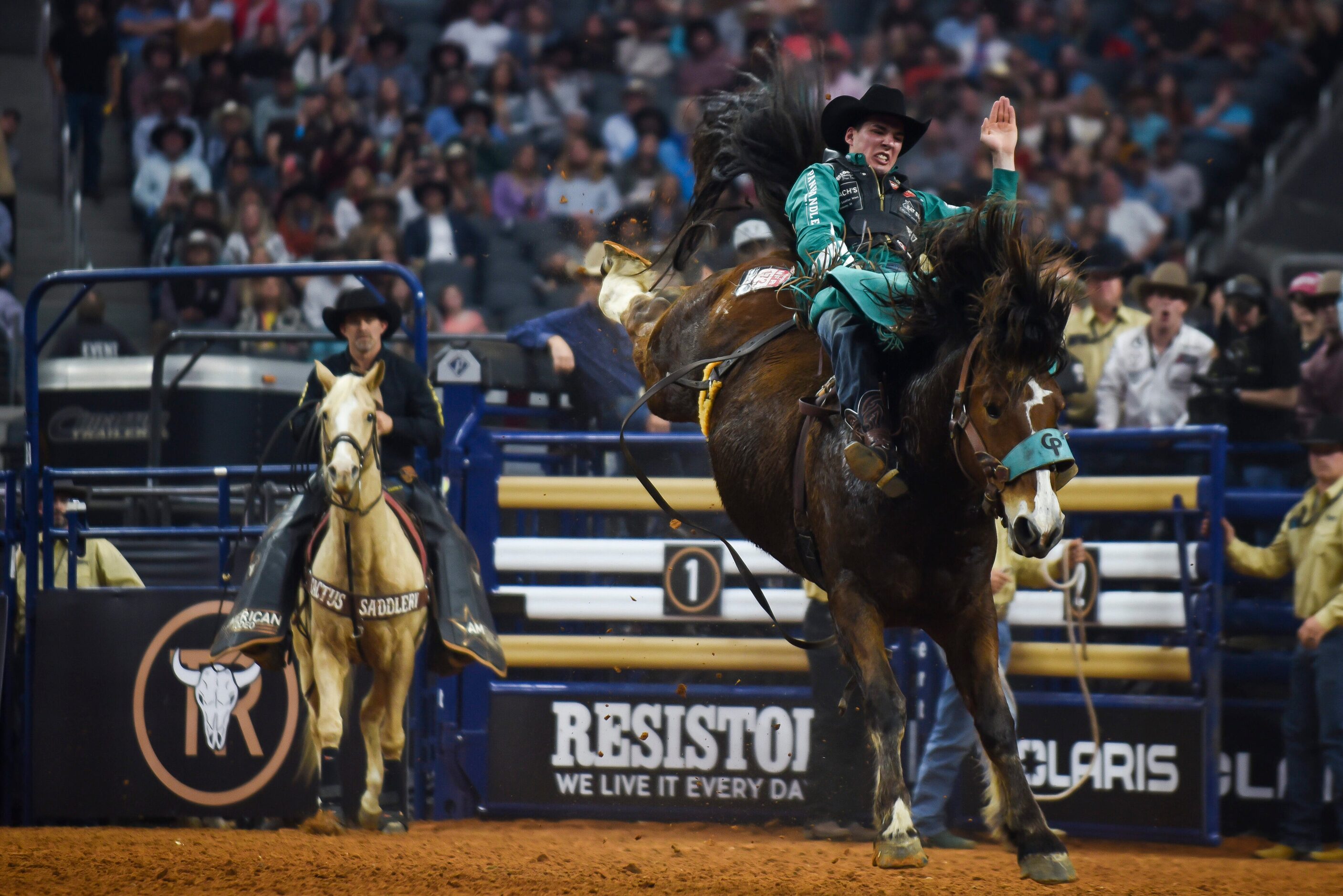 Jesse Pope attempts to stay on his horse as a part of the Bareback Bronc event during the...