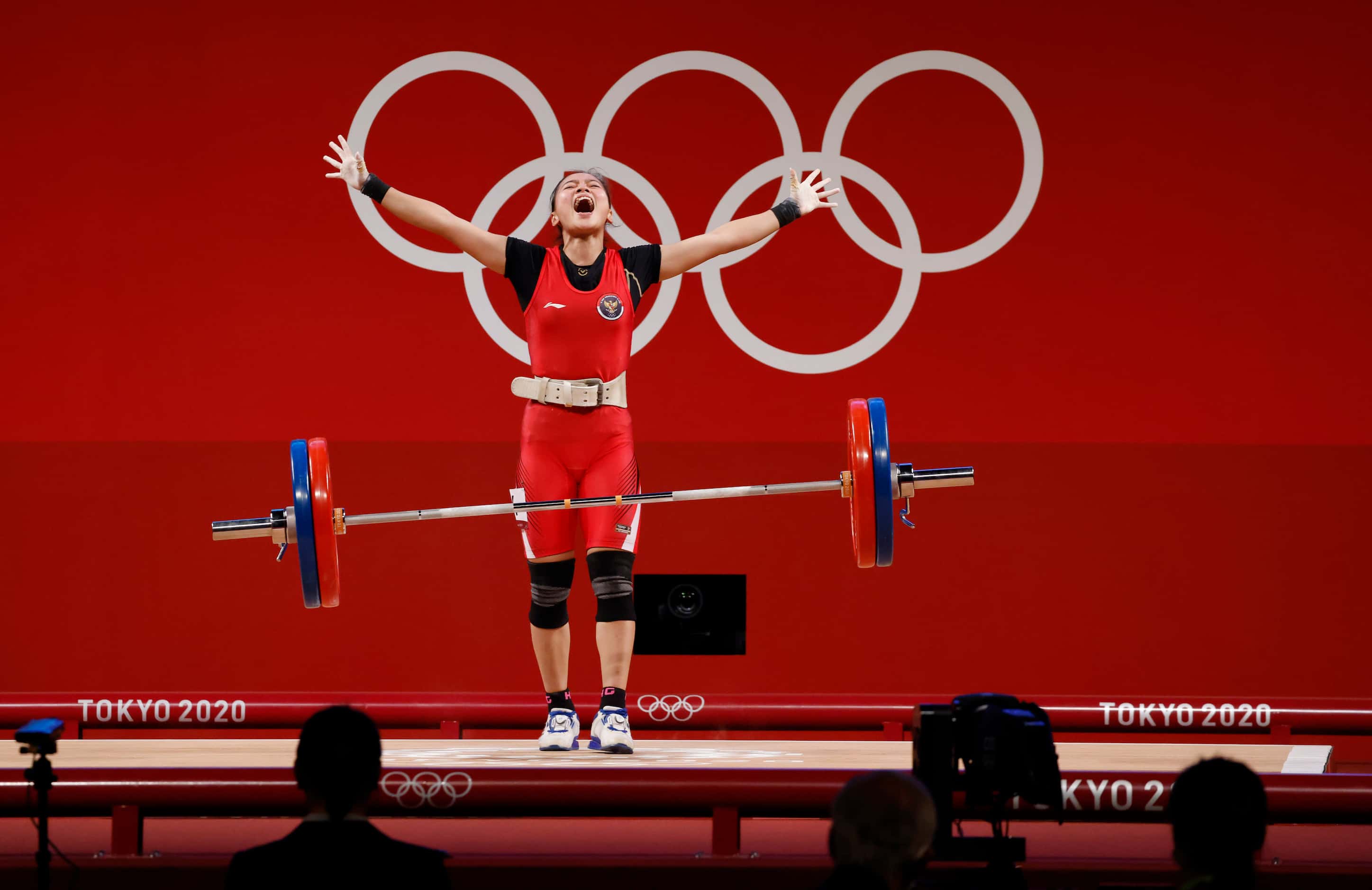 Indonesia’s Windy Cantika Aisah celebrates after a successful clean and jerk of 110 kg in...