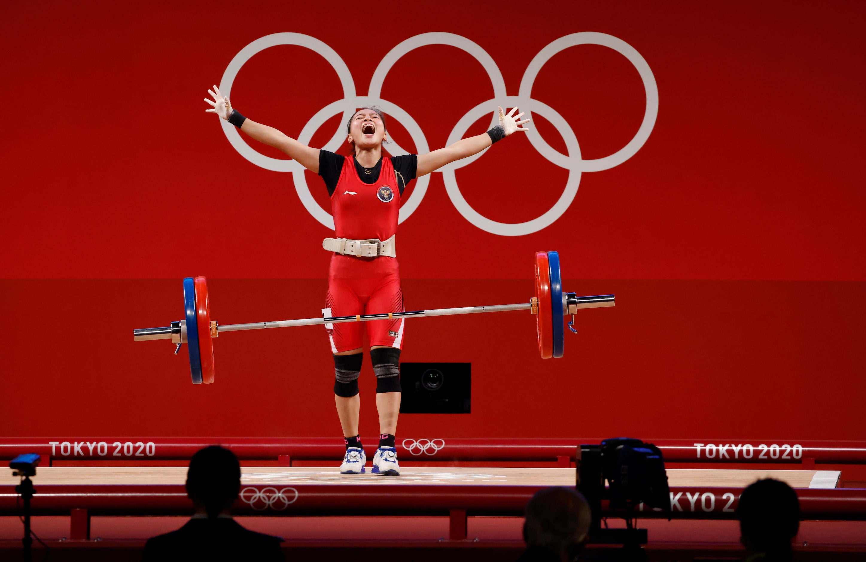 Indonesia’s Windy Cantika Aisah celebrates after a successful clean and jerk of 110 kg in...