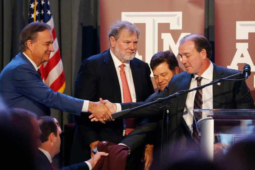 Texas A&M's new coach Jimbo Fisher (right) shakes hands with A&M Chancellor John Sharp with...