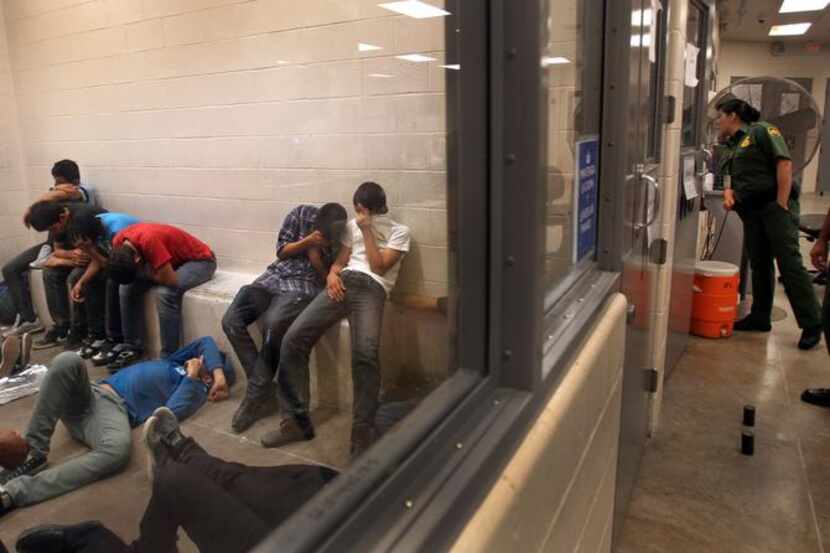 
Immigrants who have been caught crossing the border illegally are housed inside the McAllen...
