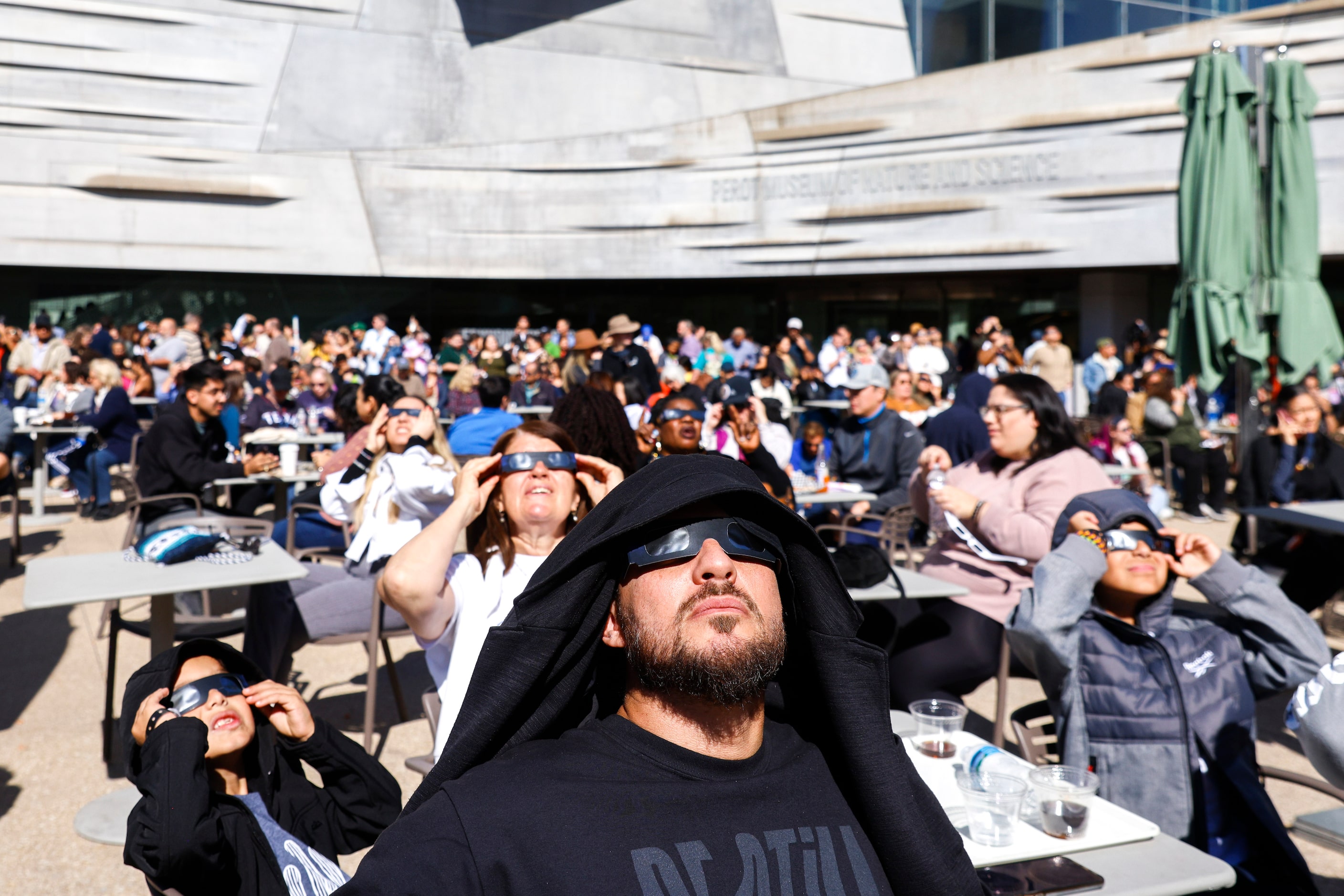 People gather to watch the annular solar eclipse on Saturday, Oct. 14, 2023, at Perot Museum...