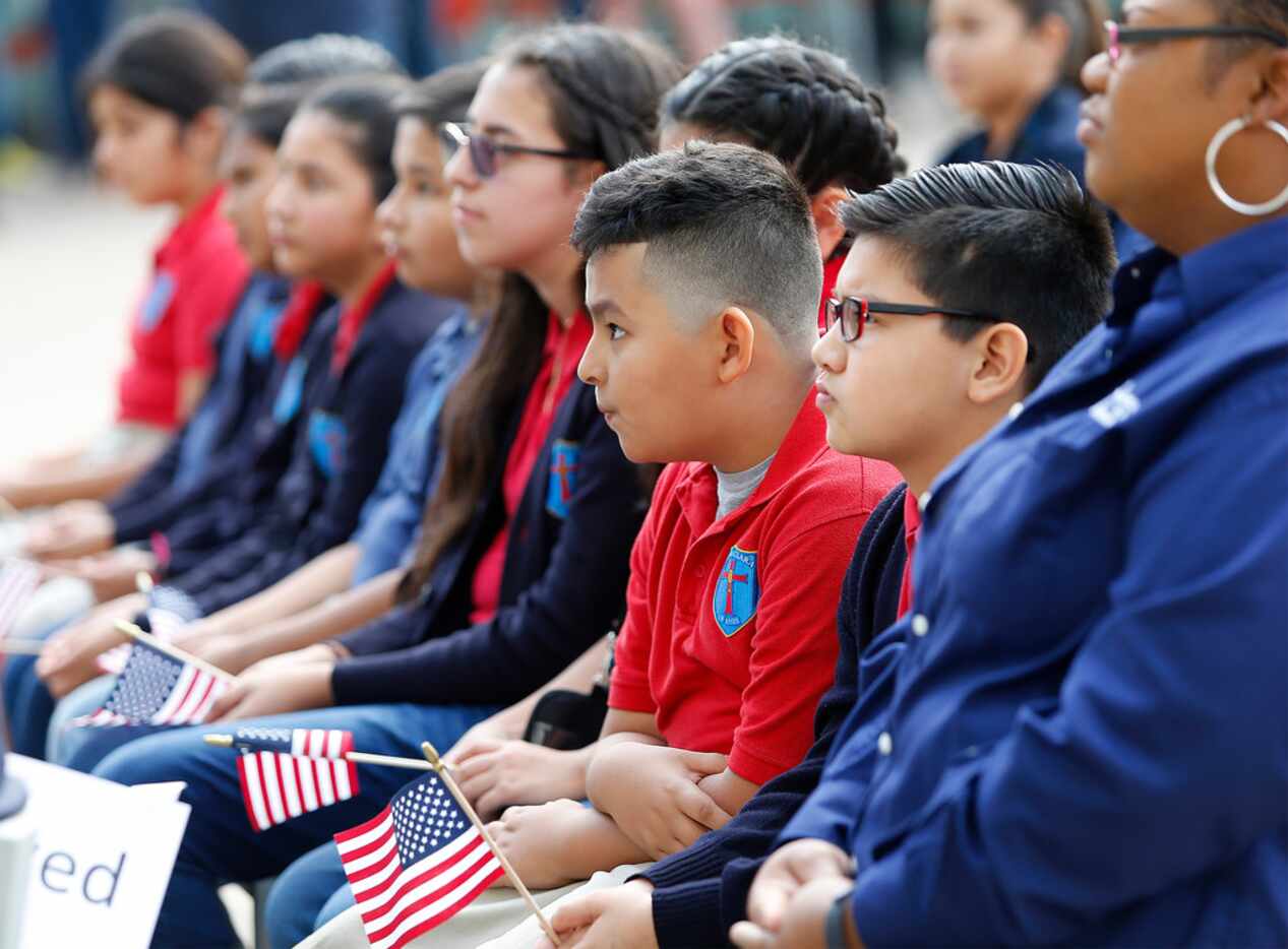 Pablo Felix, 10, of Dallas listens with classmates from Santa Clara of Assisi Catholic...