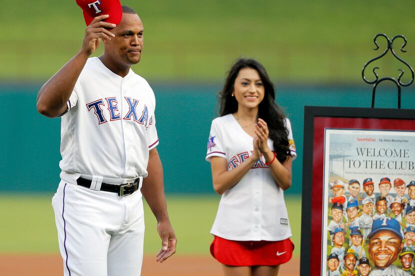 Texas Rangers third baseman Adrian Beltre tips his cap as fans cheer during a ceremony in...