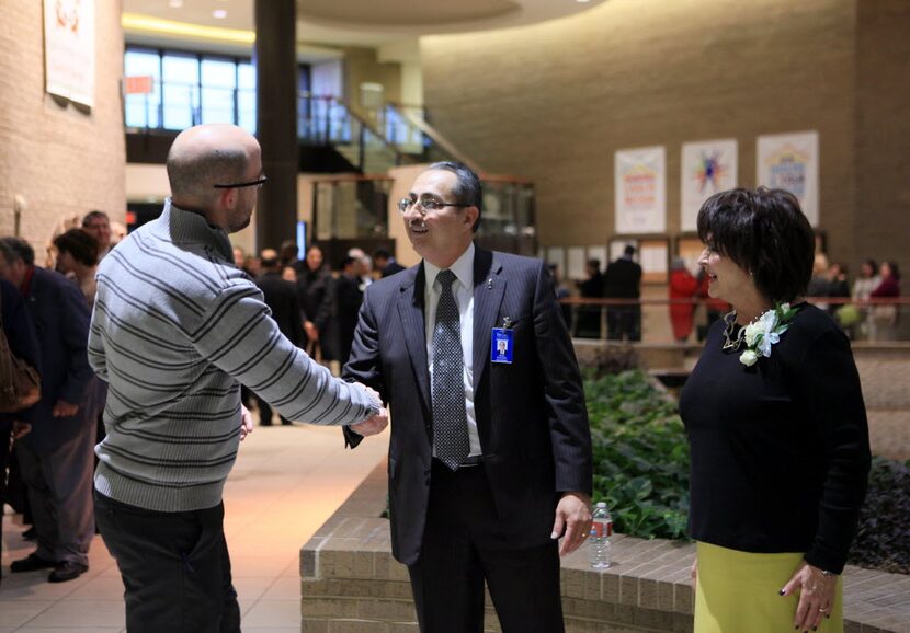 Garrett Landry (left), policy program coordinator for Teaching Trust, meets with new Irving...