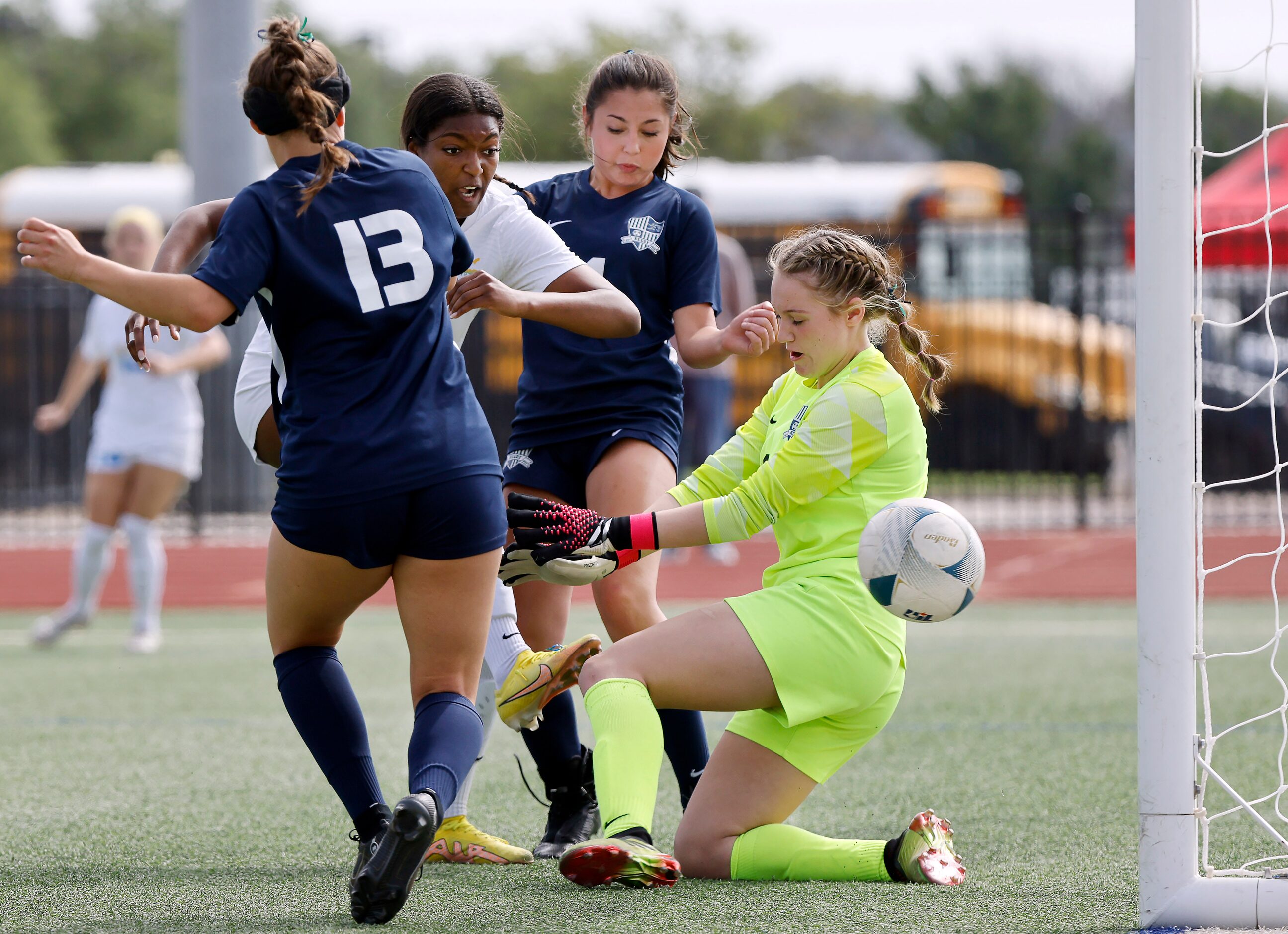 Frisco forward Kori Ballard (19, center) shoots and scores on Frisco Reedy goalkeeper...