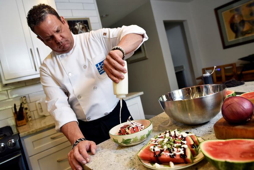 John Lymberopoulos, executive chef for the Greek Food Festival, drizzles feta sauce on a...