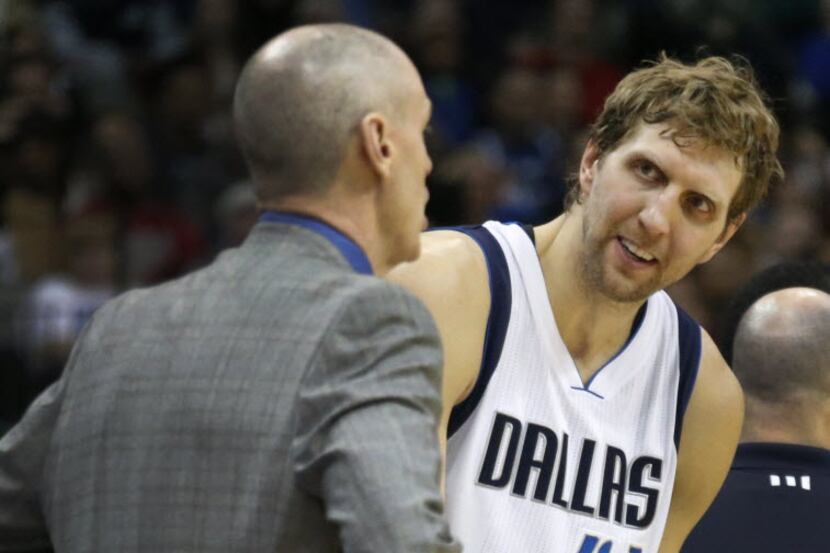Dallas Mavericks forward Dirk Nowitzki (41) talks with head coach Rick Carlisle during the...