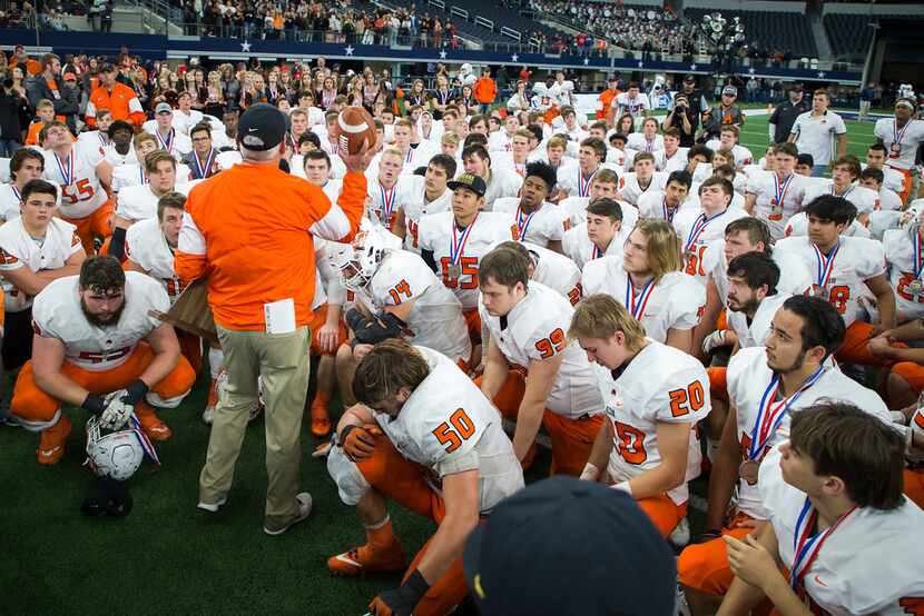 Aledo players huddle around head coach Steve Wood after a loss to College Station in the...