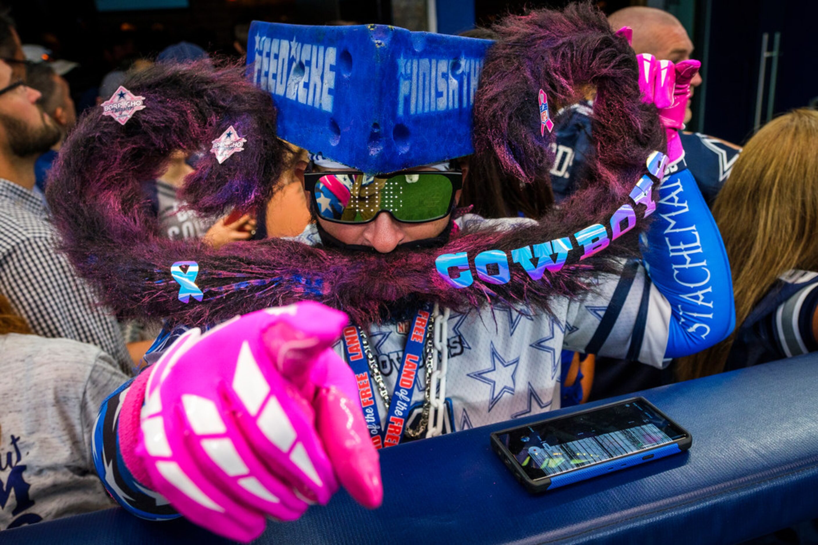 Dallas Cowboys fans cheer as their team warms up before an NFL football game against the...