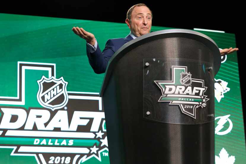 FILE - NHL Commissioner Gary Bettman responds to booing during his opening remarks at the...