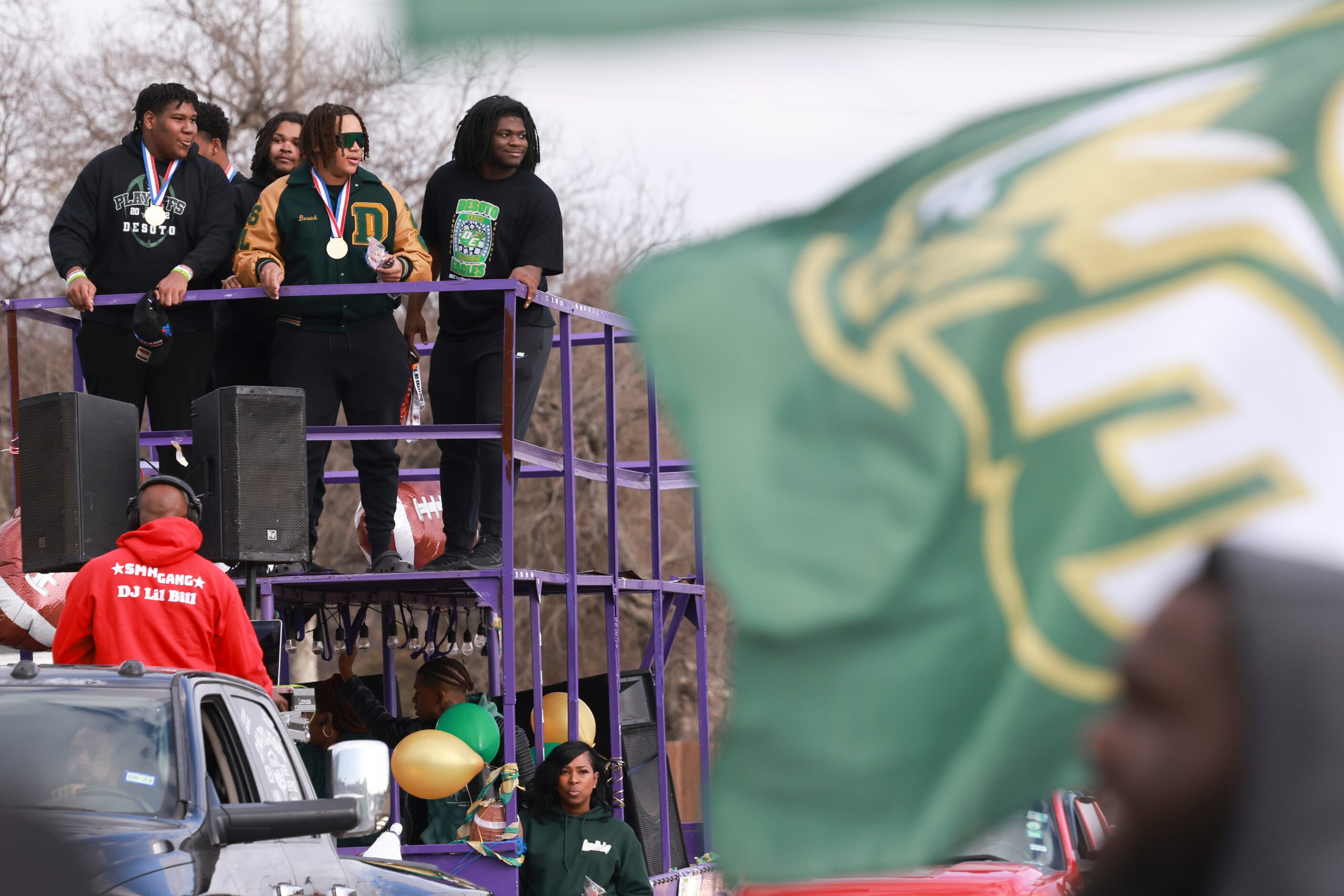 DeSoto High School football players ride on top of a double-decker trailer, Saturday, Jan....