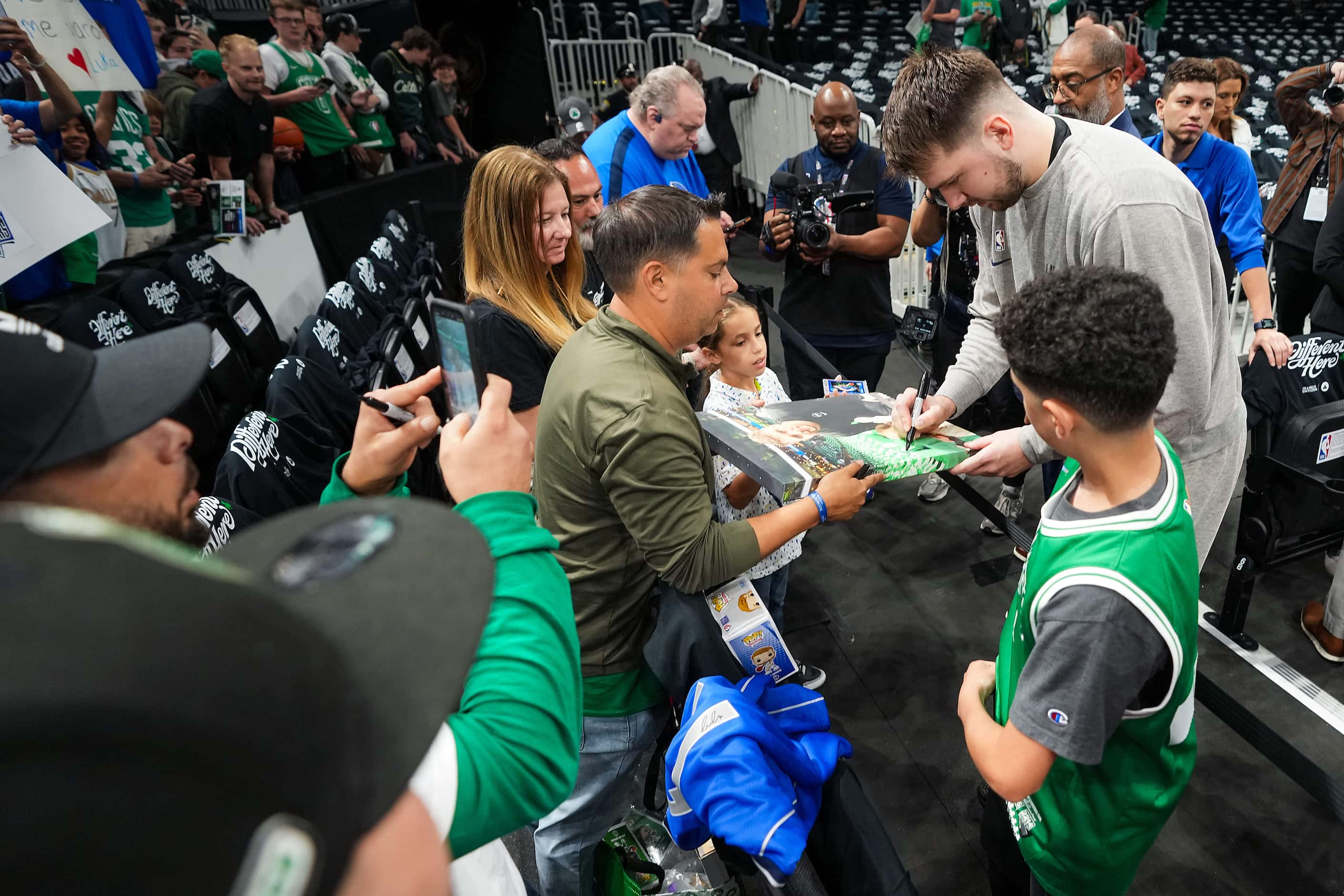 Dallas Mavericks guard Luka Doncic signs autographs before Game 2 of the NBA Finals against...