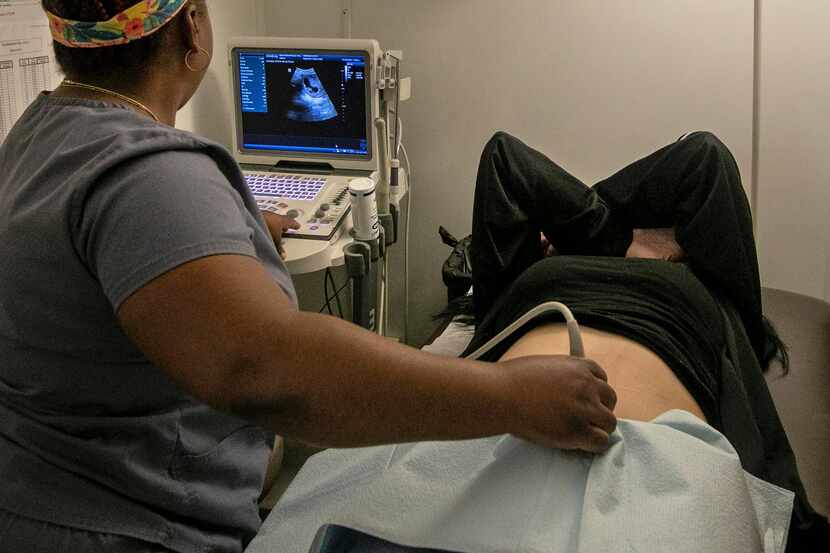 An operating room technician performs an ultrasound on a patient at an abortion clinic in...
