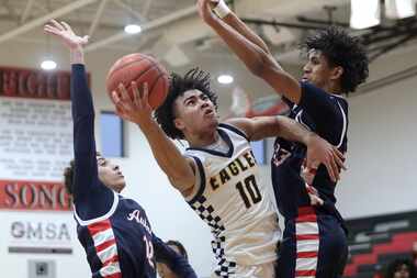 Oak Cliff Faith Family guard Isaac Williams (10) goes up for a shot between Aubrey High...