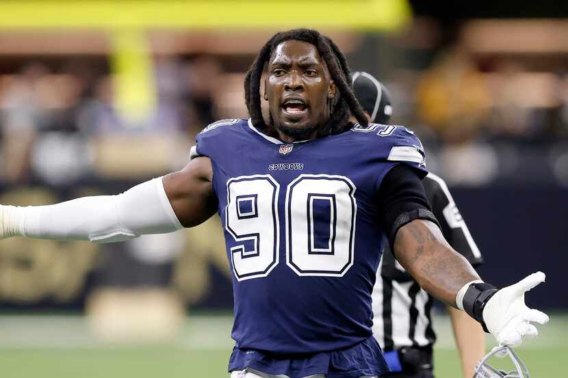 Dallas Cowboys defensive end Demarcus Lawrence (90) reacts to his teammates' play during a...