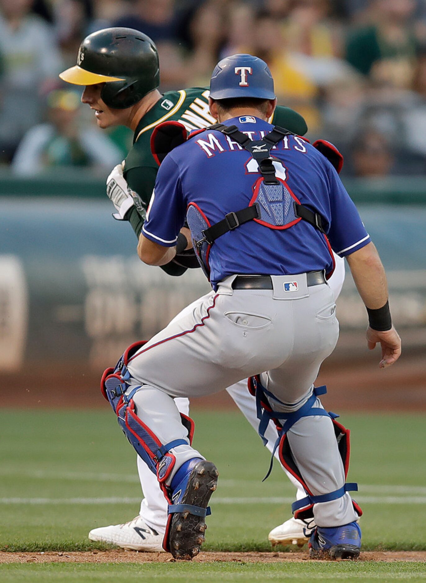 Texas Rangers catcher Jeff Mathis, right, tags out Oakland Athletics' Mark Canha in a...