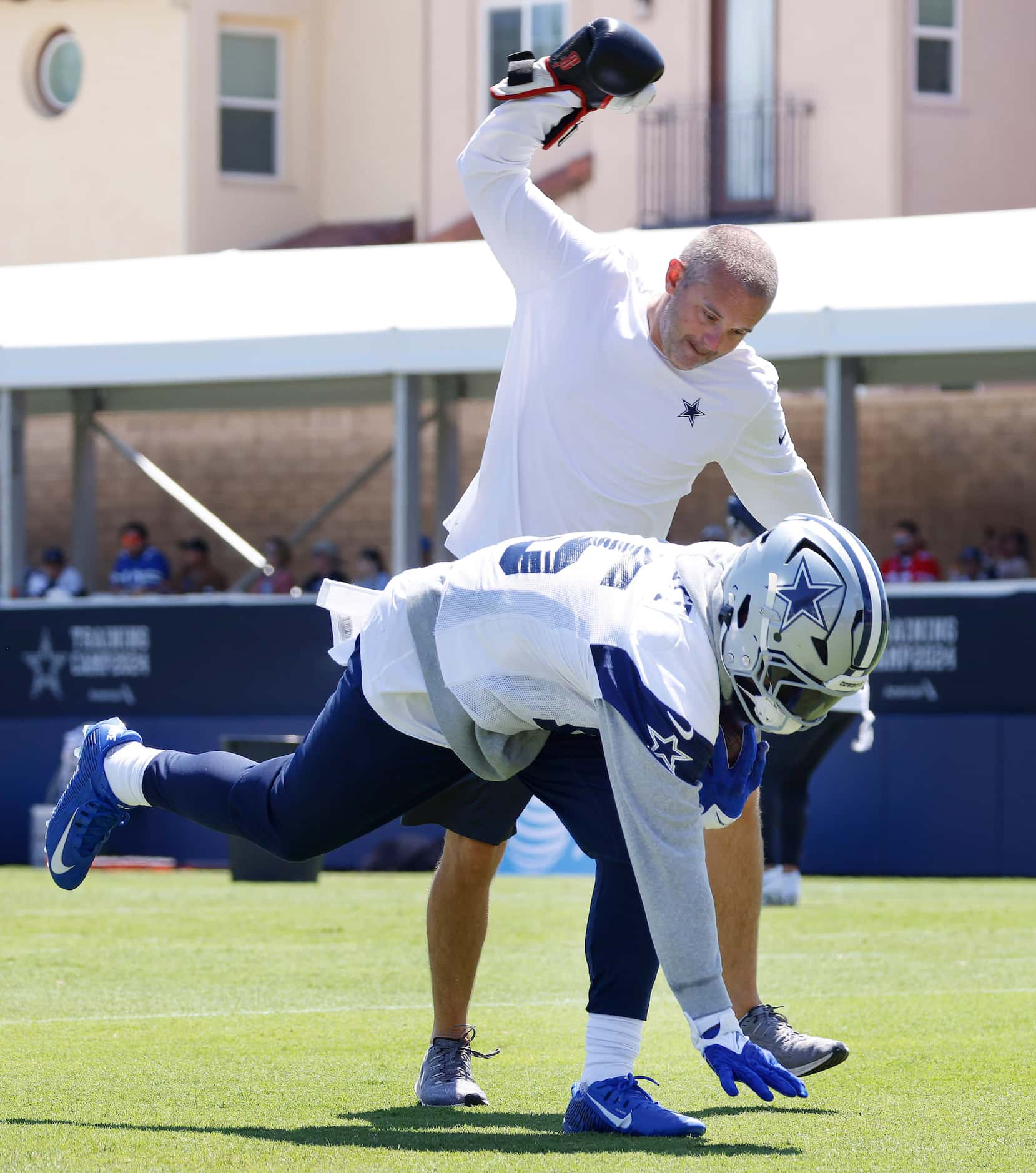 Dallas Cowboys running back Ezekiel Elliott (15) runs a drill where he continually takes...
