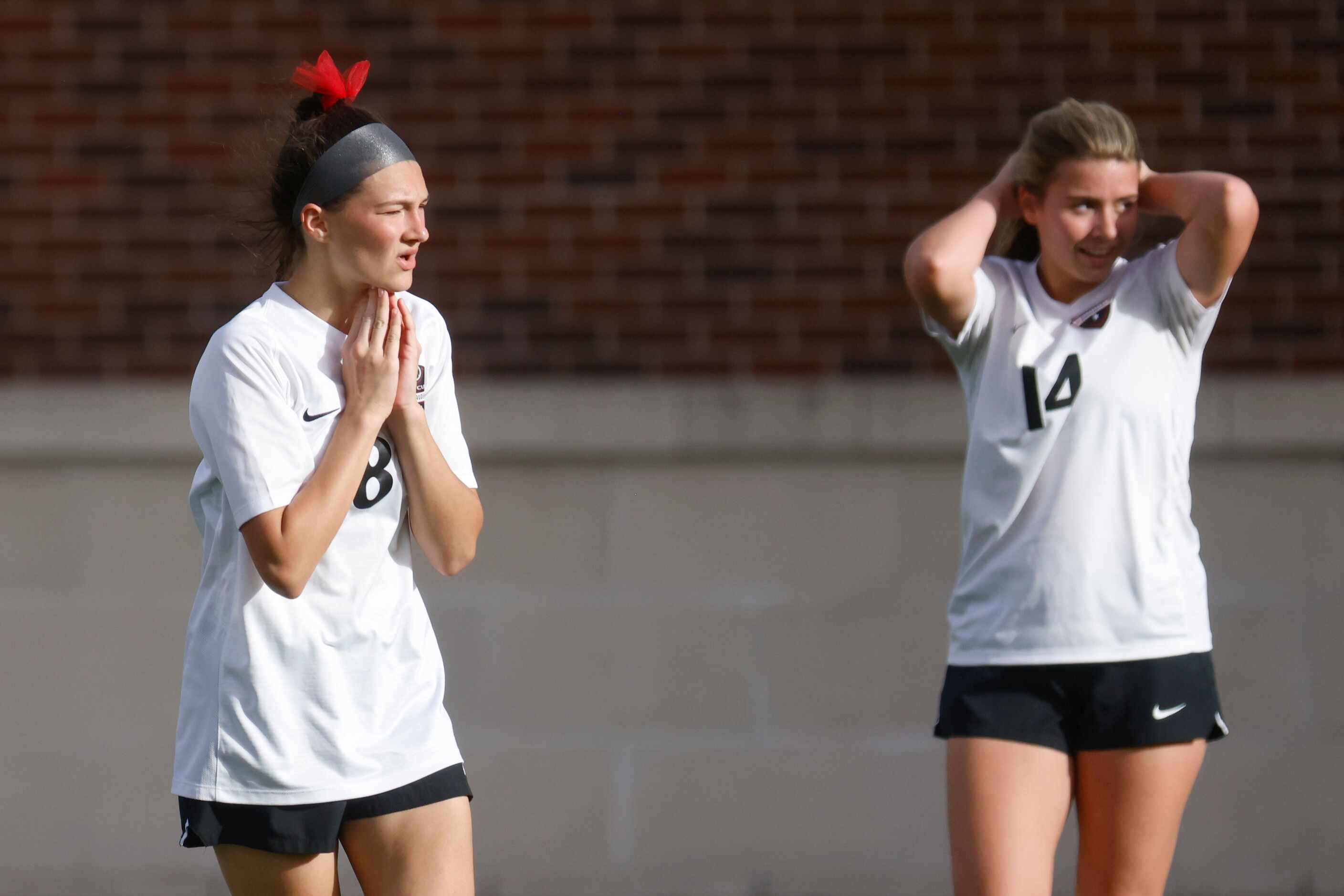 Marcus’ Emma Fioretti (left) and Piper Garcia reacts after a close call goal attempt by...