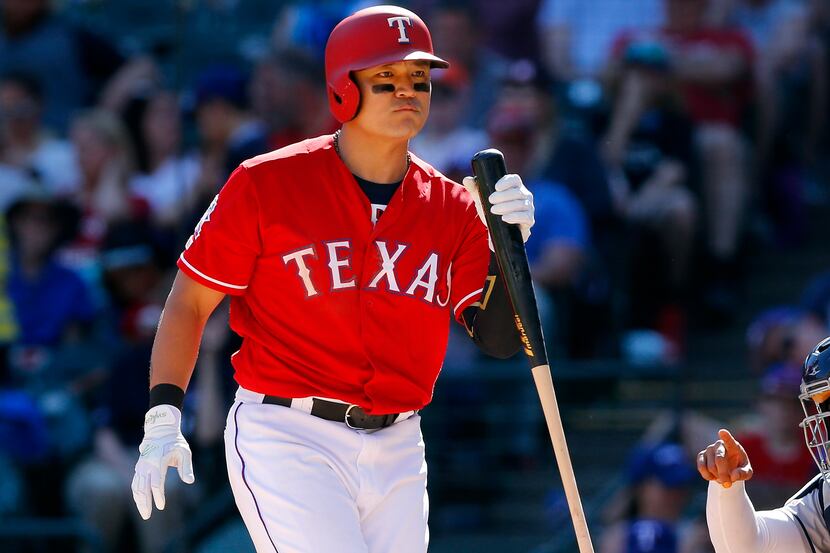 Texas Rangers batter Shin-Soo Choo (17) reacts at the plate as he bats in the eighth inning...
