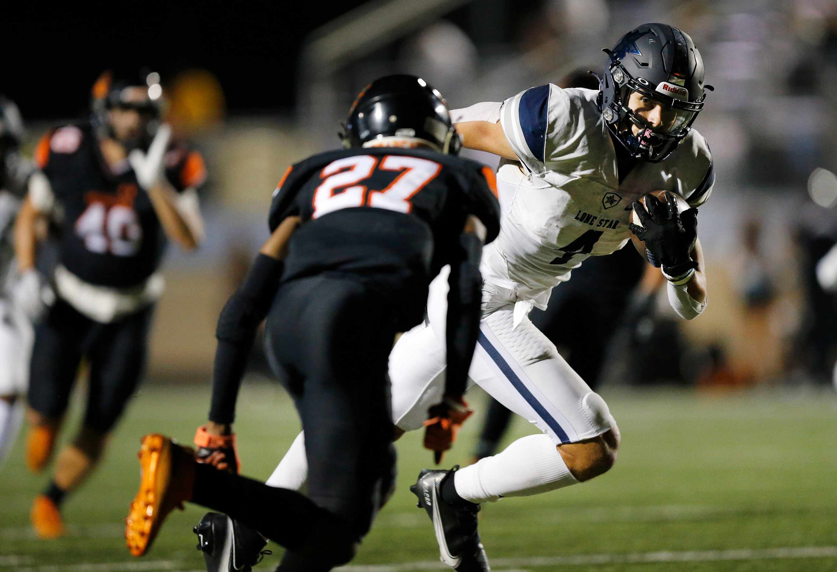 Frisco Lone Star wide receiver Trace Bruckler (4) catches a pass and looks to elude Aledo's...