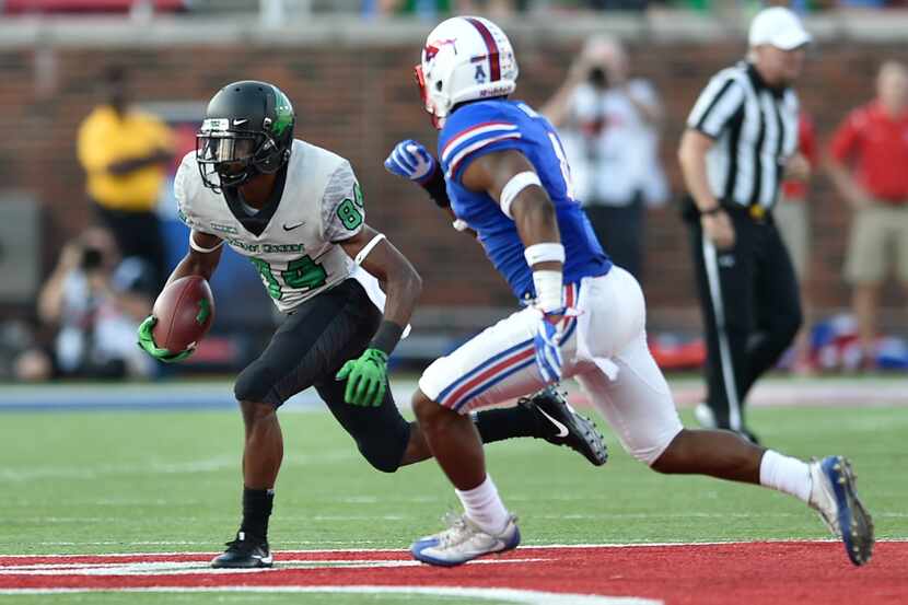North Texas wide receiver Jaelon Darden (84) catches a pass, while being defended by...