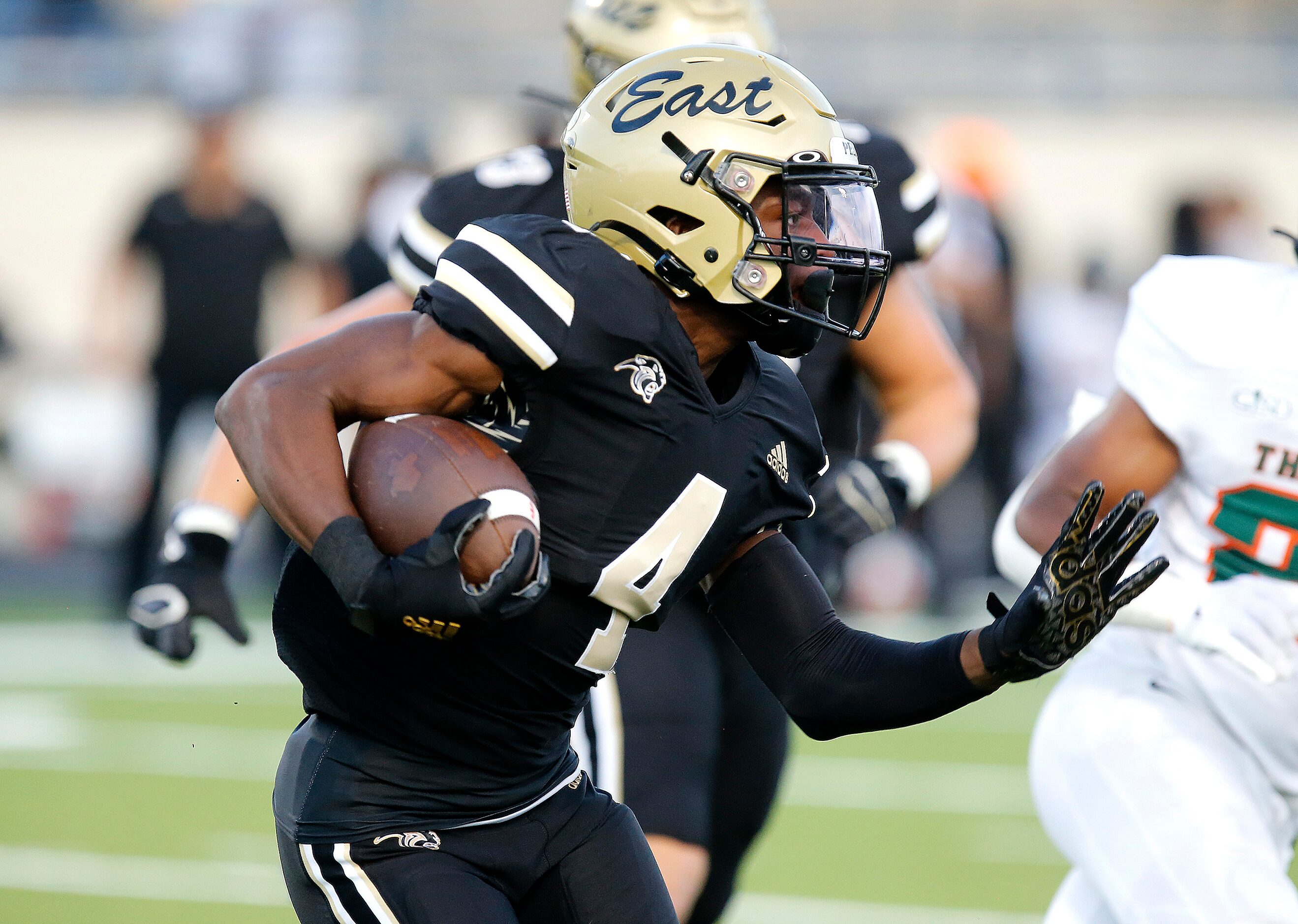 Plano East Senior High School running back Daniel Fayombo (4) carries the football during...