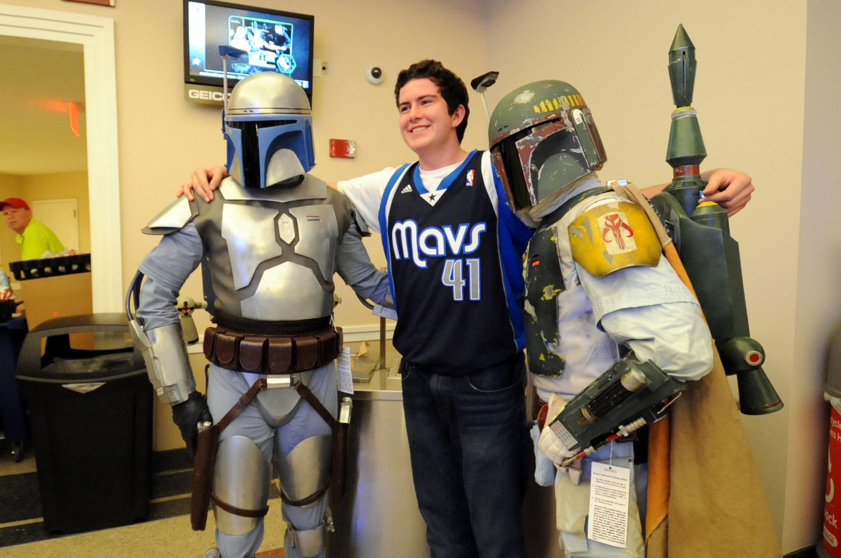 A fan meets Jango Fett and Boba Fett at Star Wars night at the Dallas Mavericks basketball...