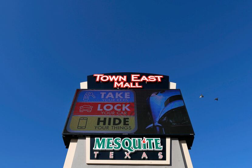 A "Take, Lock, Hide" sign is seen at Town East Mall in Mesquite.