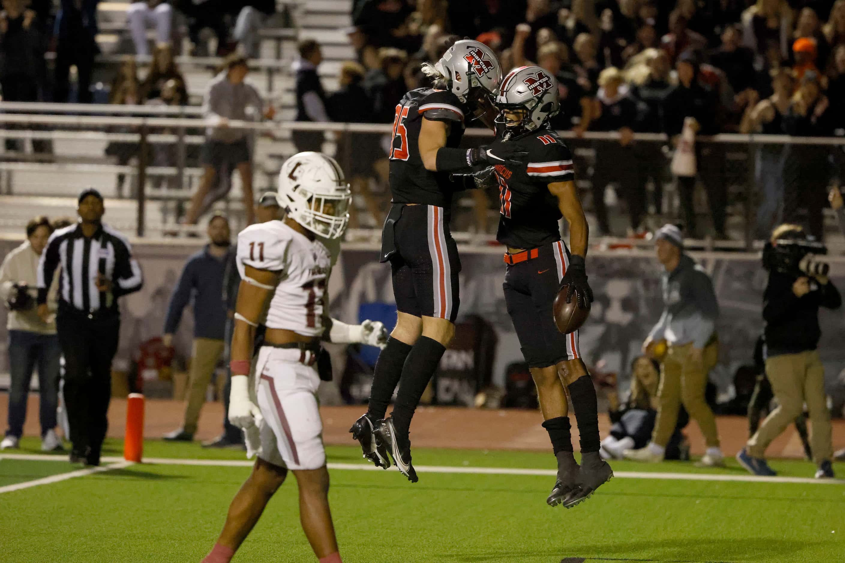 Flower Mound Marcus receiver Dallas Dudley (11), right. celebrates his touchdown against...