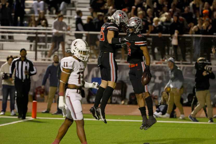 Flower Mound Marcus wide receiver Dallas Dudley (right) celebrates his touchdown against...